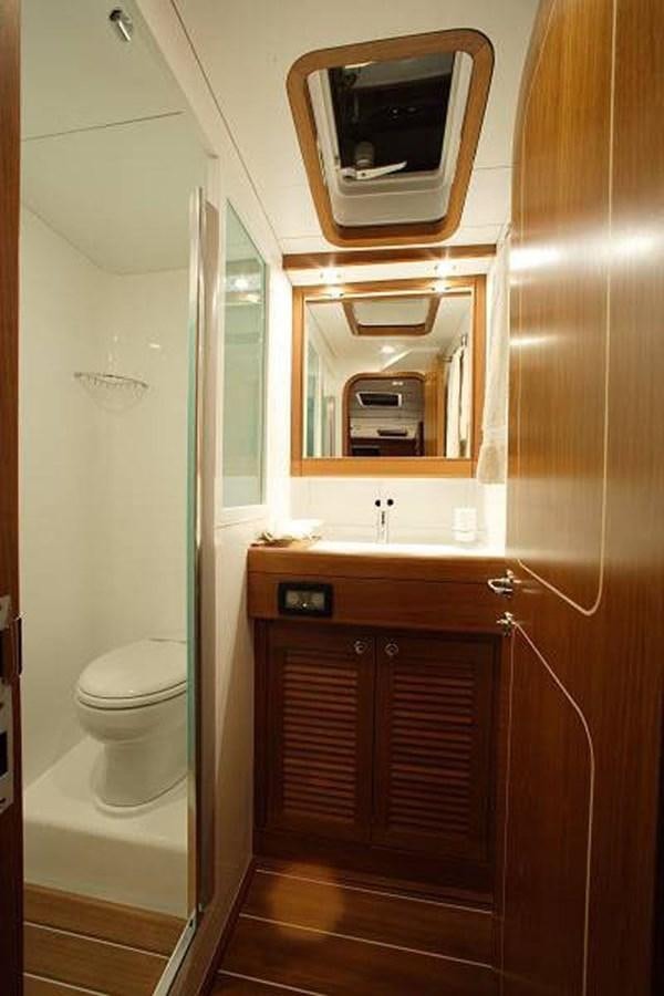 a bathroom with a toilet and a sink aboard STARFALL Yacht for Sale