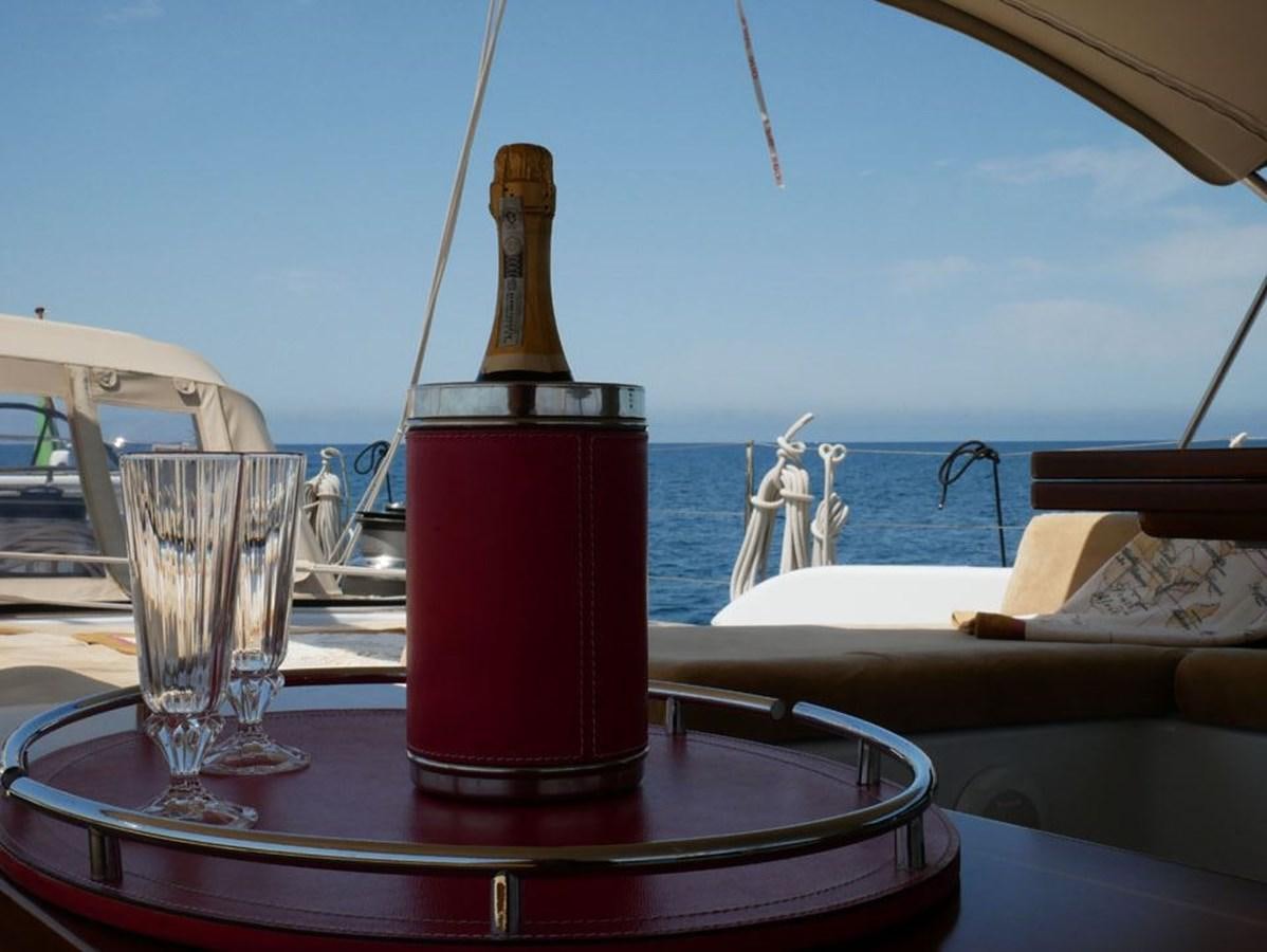 a red and white object on a table with a glass of liquid and a straw on a boat aboard STARFALL Yacht for Sale