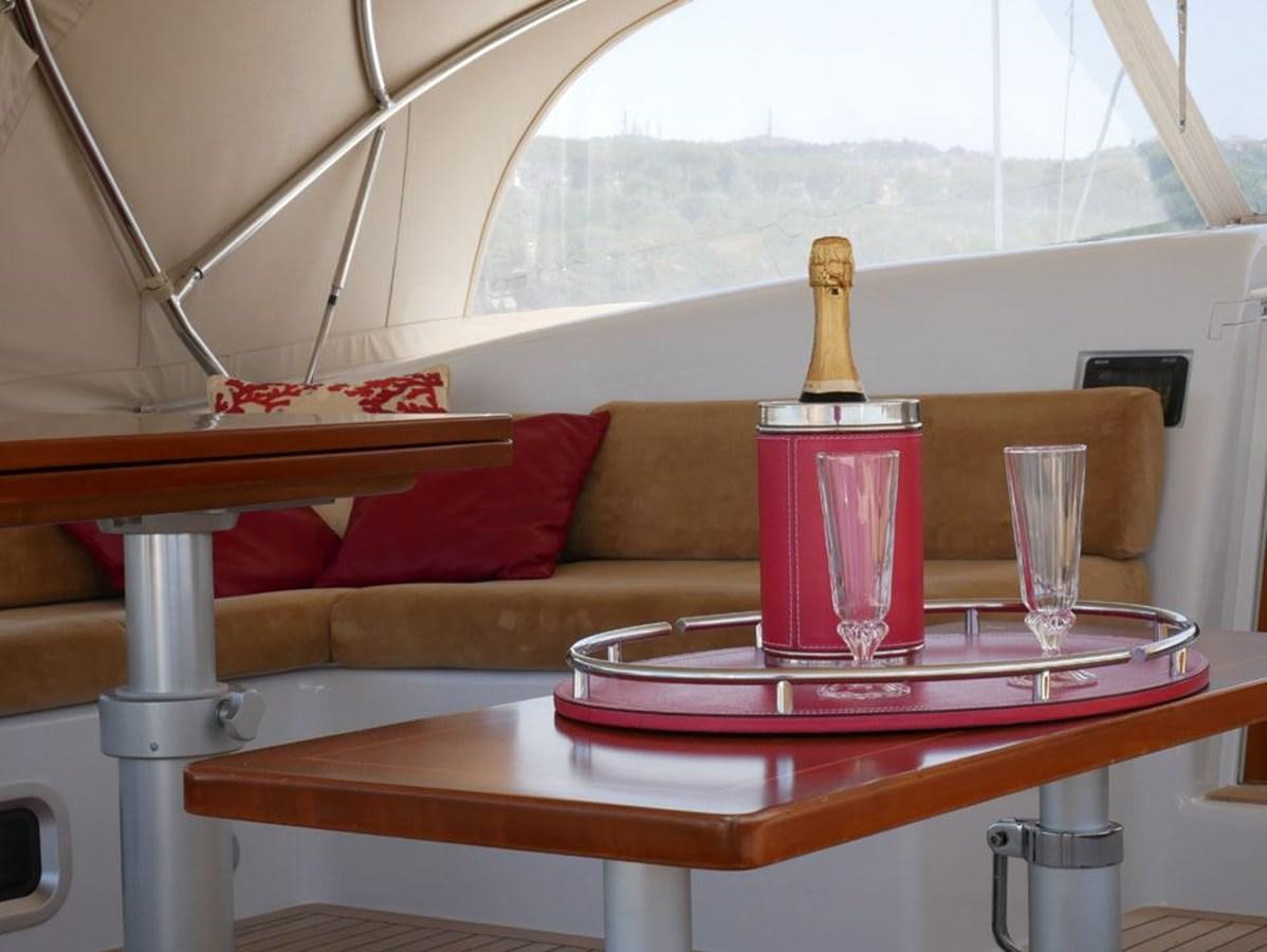 a red glass bottle on a table aboard STARFALL Yacht for Sale