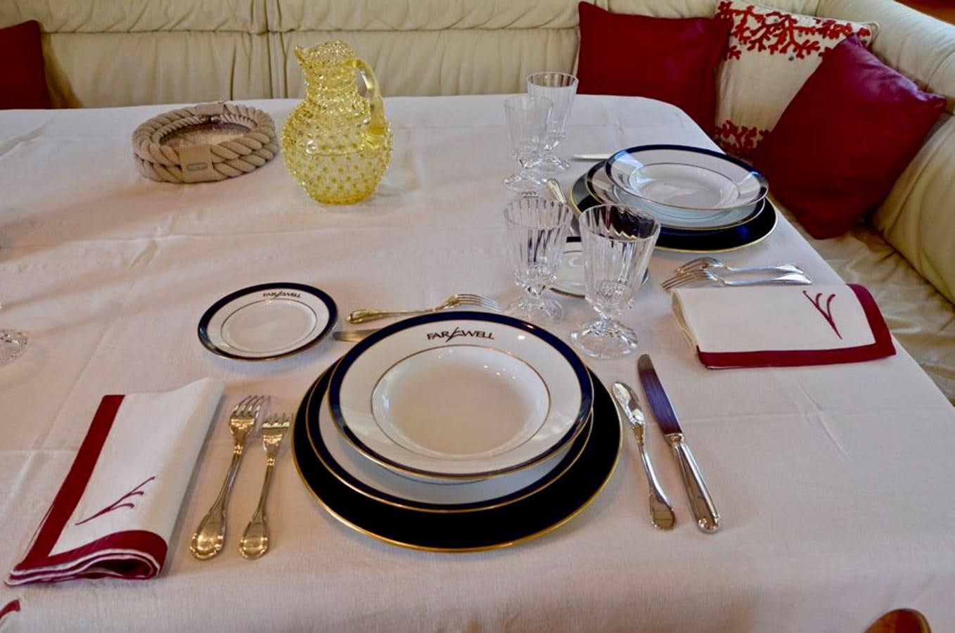 a table with plates and silverware aboard STARFALL Yacht for Sale