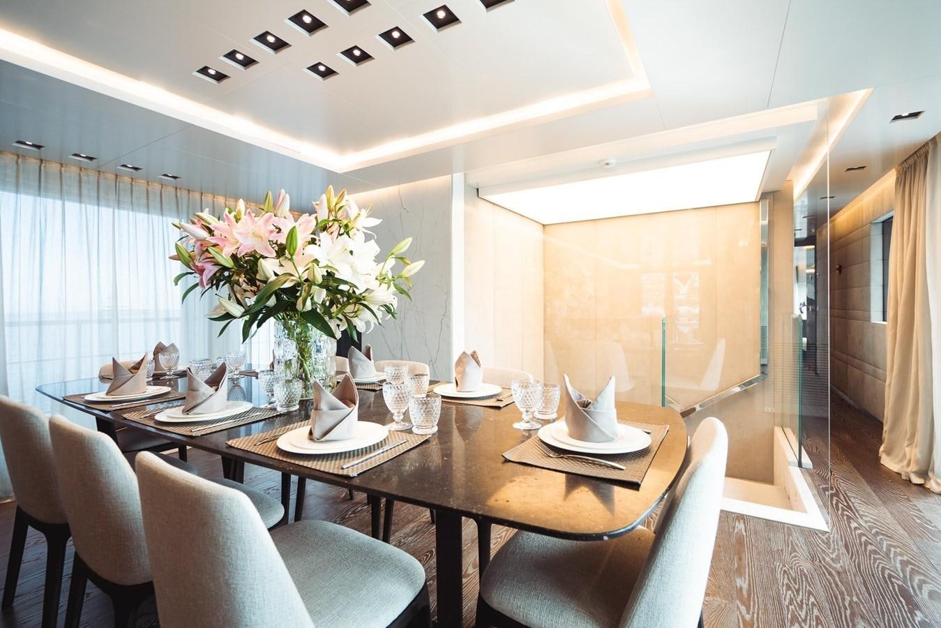 a dining room with a table and chairs aboard JESMA II Yacht for Charter