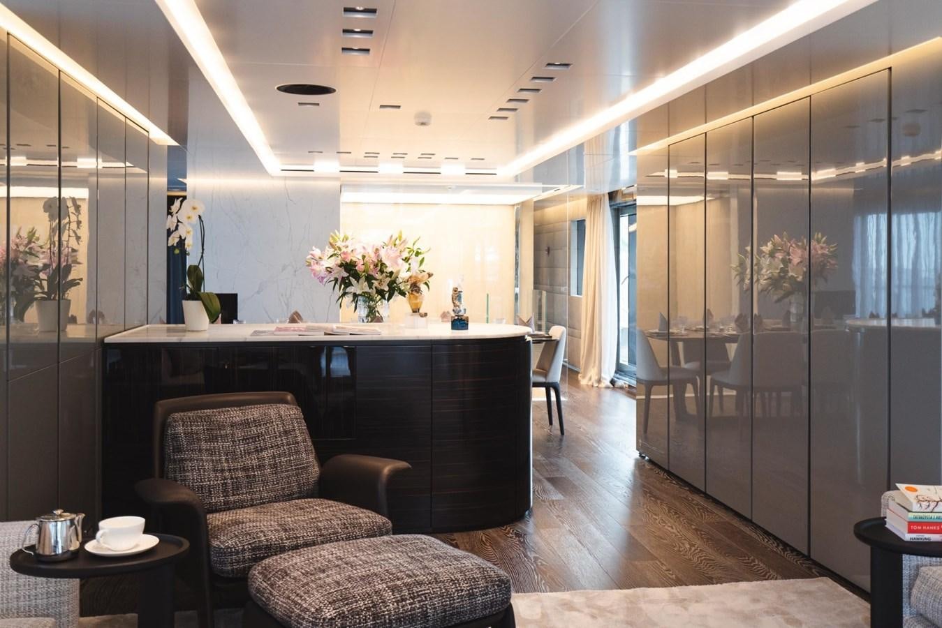 a room with a table chairs and a large glass door aboard JESMA II Yacht for Charter