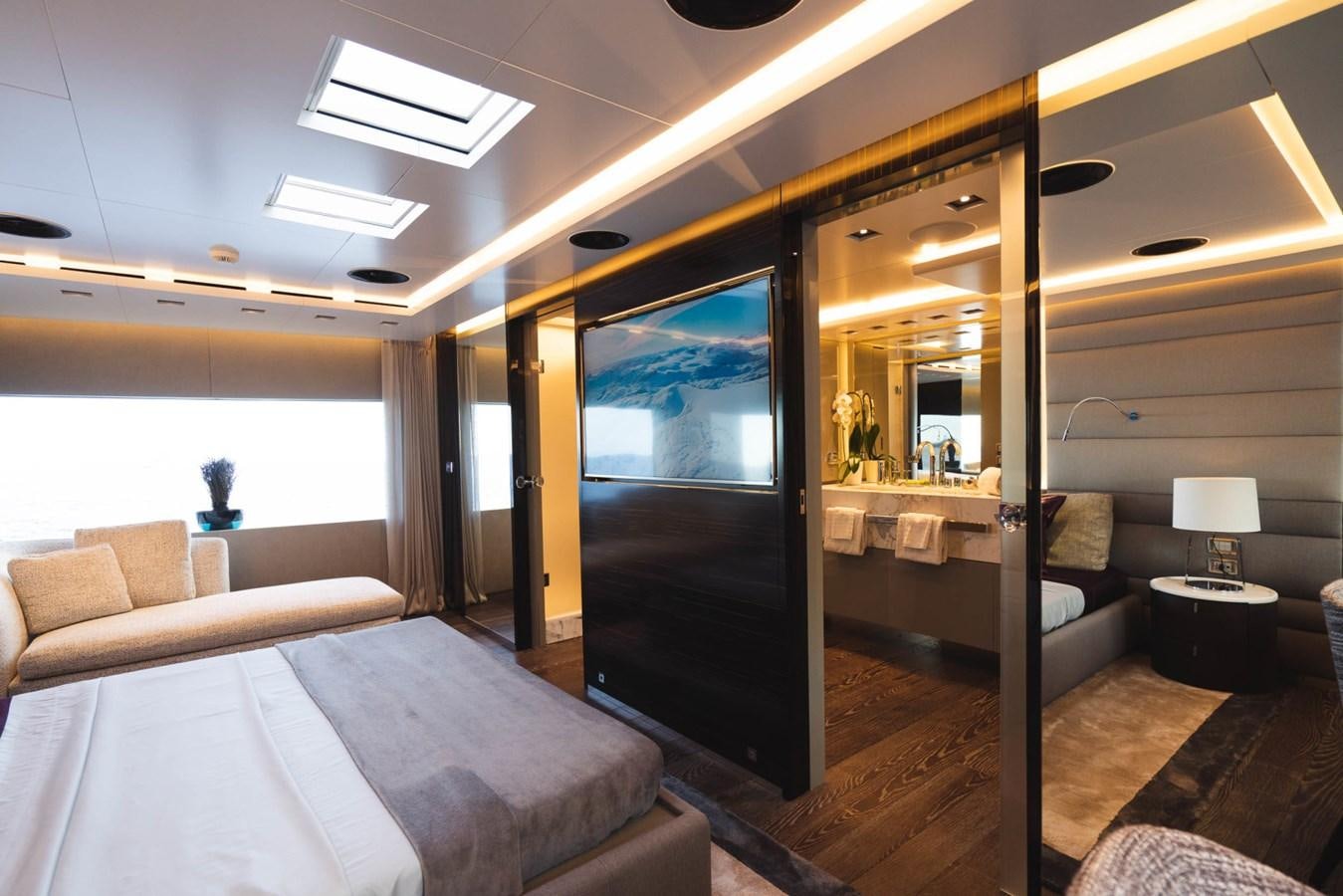 a room with a bed and a large mirror aboard JESMA II Yacht for Charter