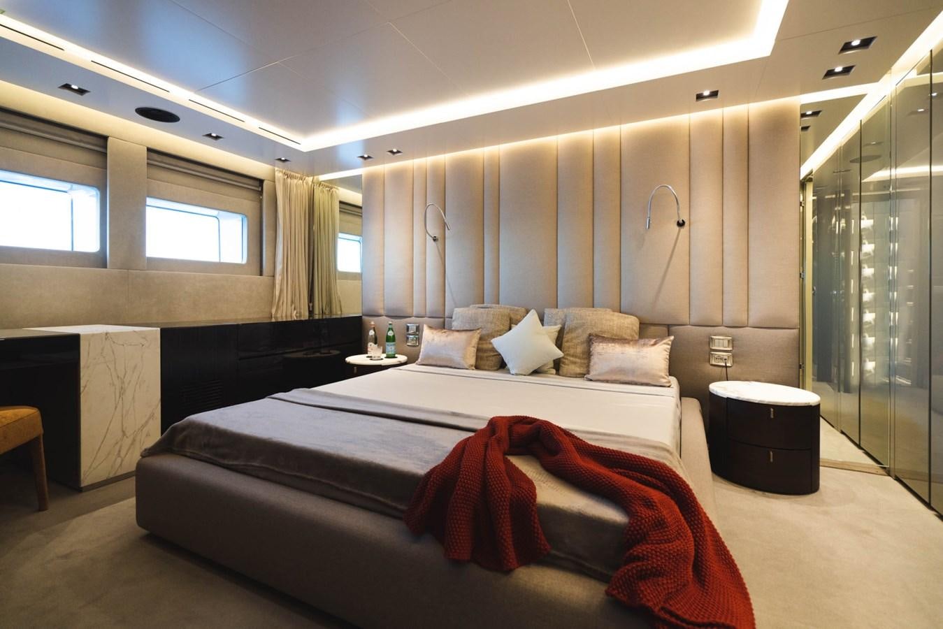 a bedroom with a bed and a window aboard JESMA II Yacht for Charter