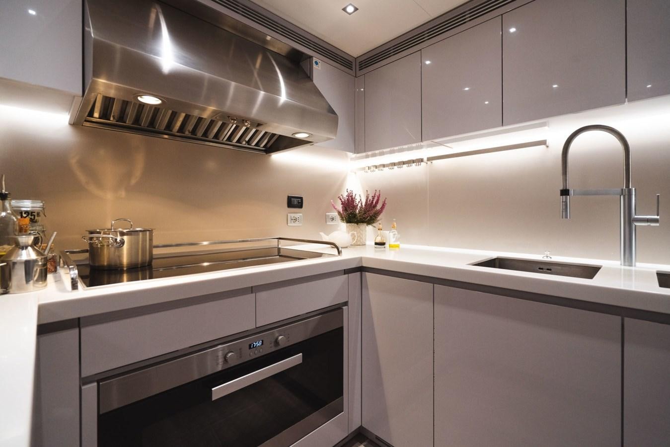a kitchen with a steel stove aboard JESMA II Yacht for Charter