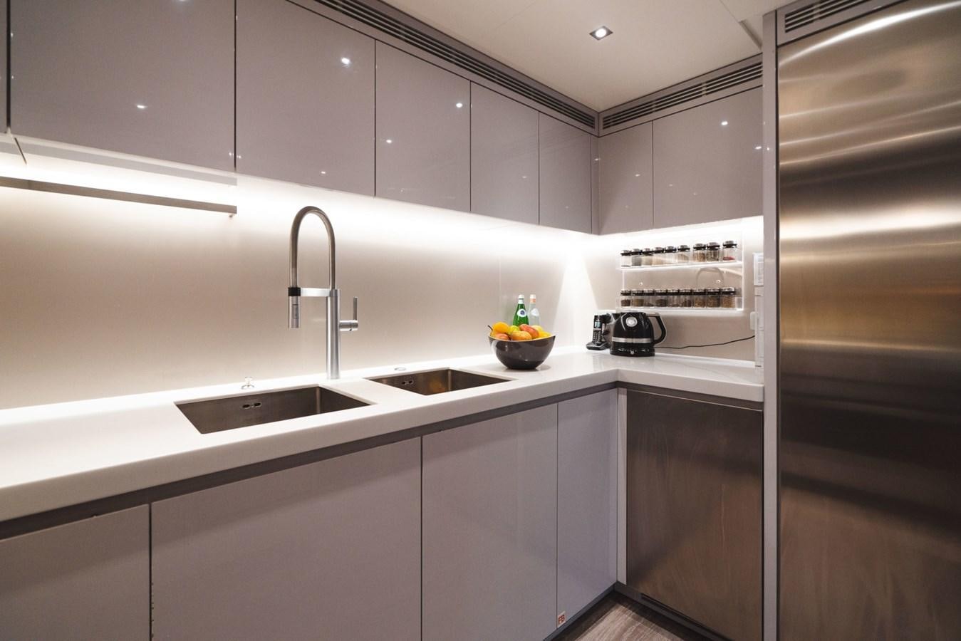 a kitchen with a sink and refrigerator aboard JESMA II Yacht for Charter