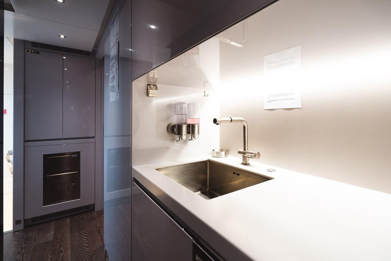 a kitchen with a sink and a stove aboard JESMA II Yacht for Charter