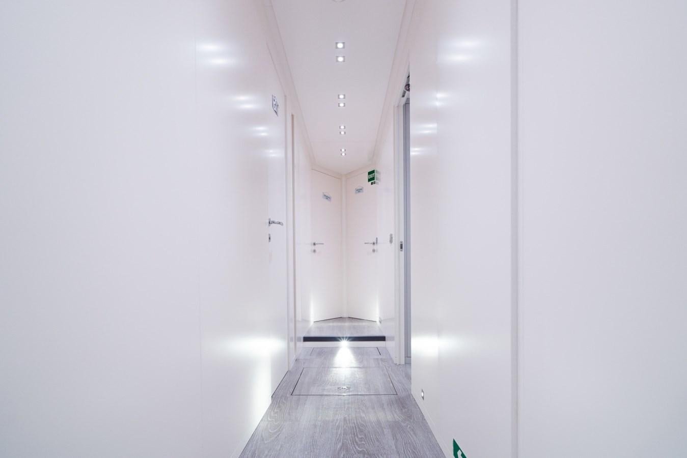 a long hallway with white doors aboard JESMA II Yacht for Charter