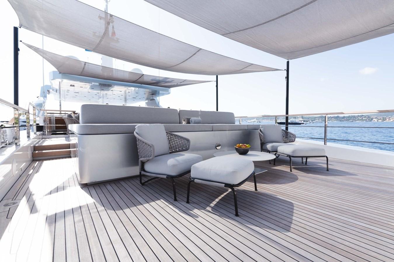 a large living room with a large patio and a large body of water aboard JESMA II Yacht for Charter