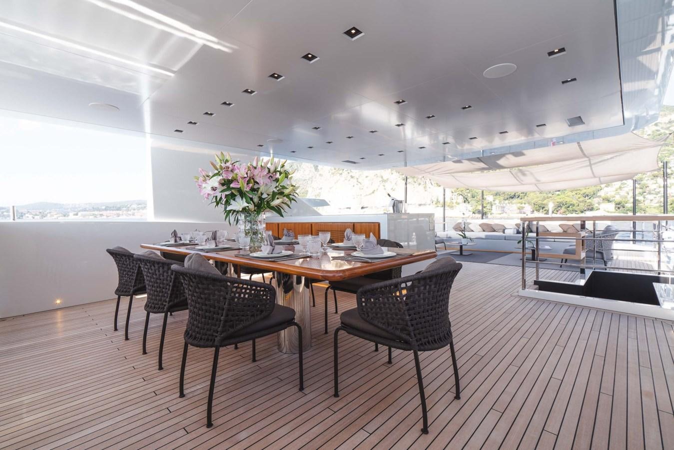 a room with a table and chairs aboard JESMA II Yacht for Charter