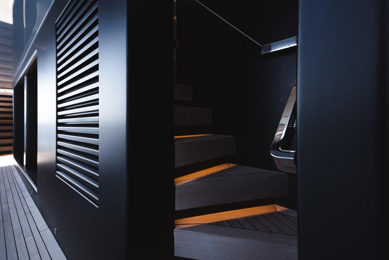 a black and white staircase aboard JESMA II Yacht for Charter