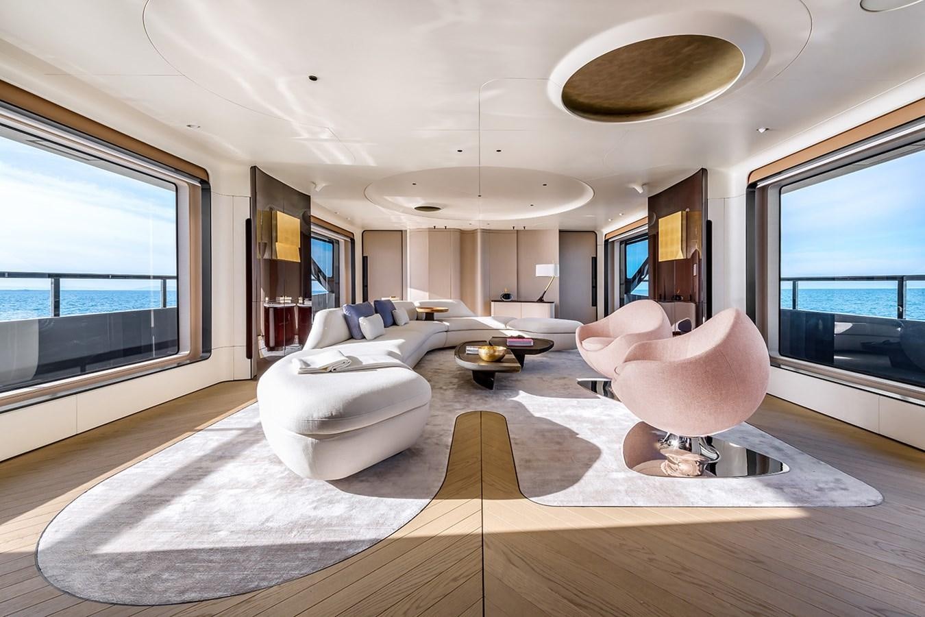 a room with a large window and a couch and a table aboard AZIMUT GRANDE TRIDECK 38M Yacht for Sale