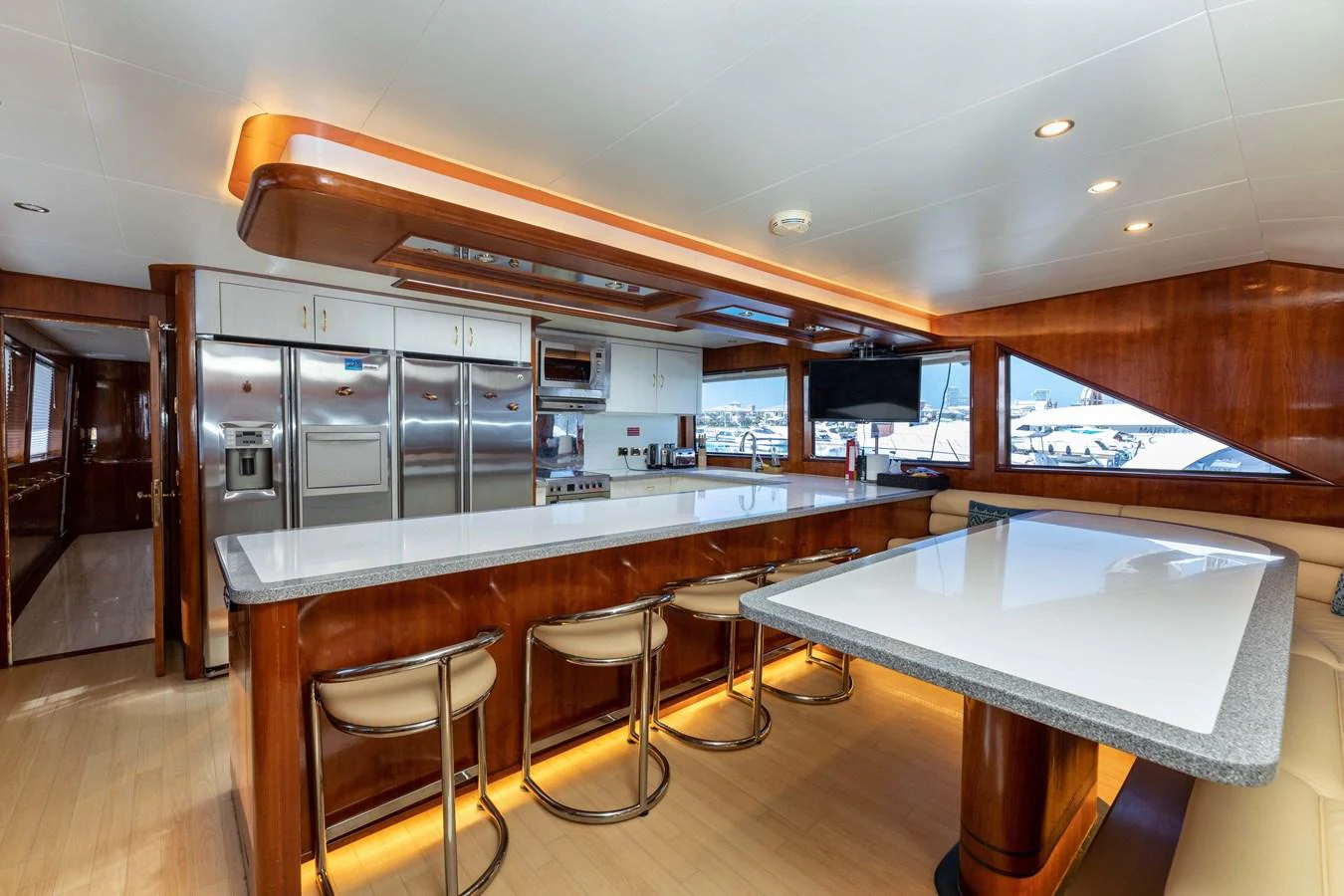 a kitchen with a bar and a table aboard WILDE WHALE Yacht for Sale
