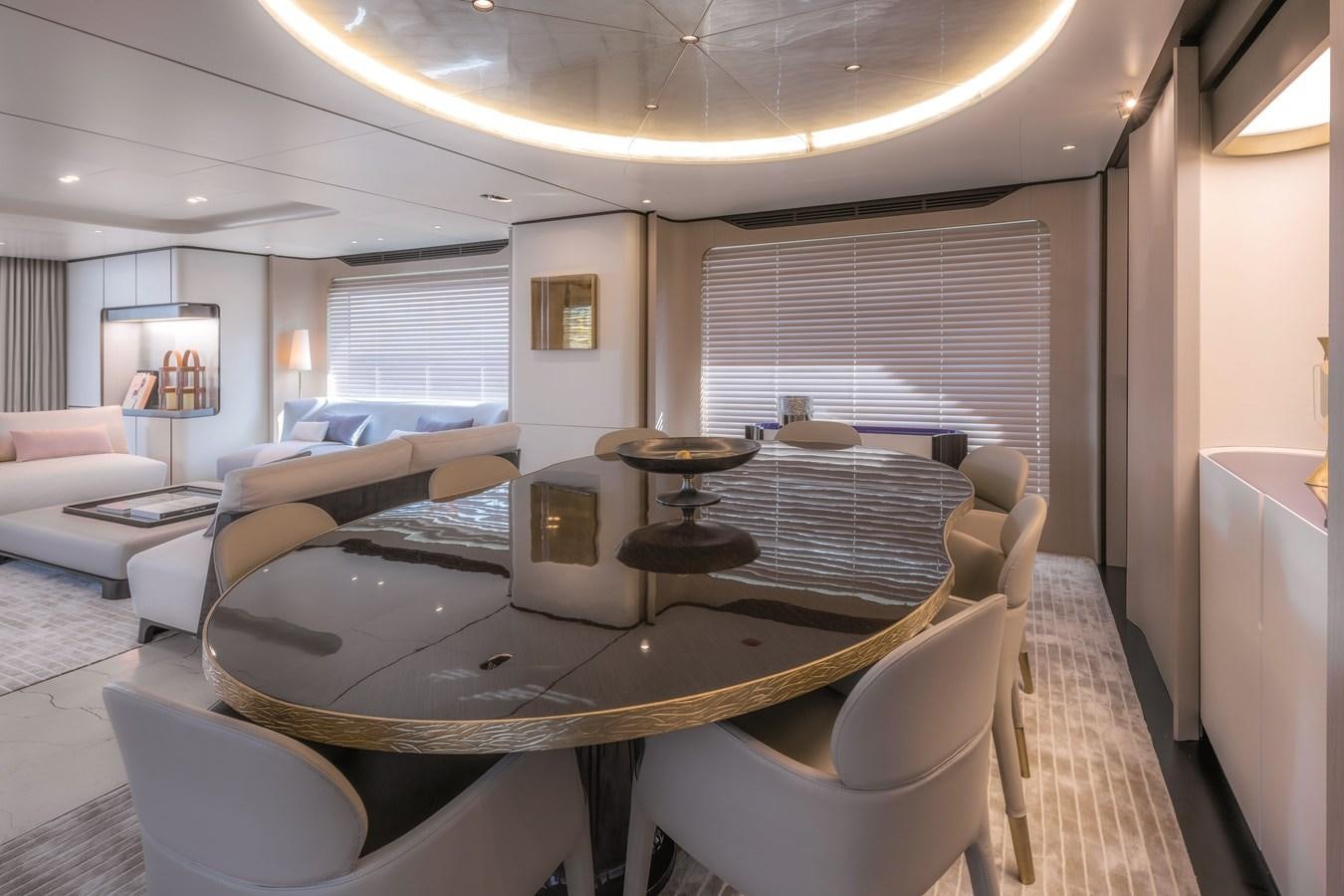 a living room with a table and chairs aboard LA MAMA Yacht for Sale