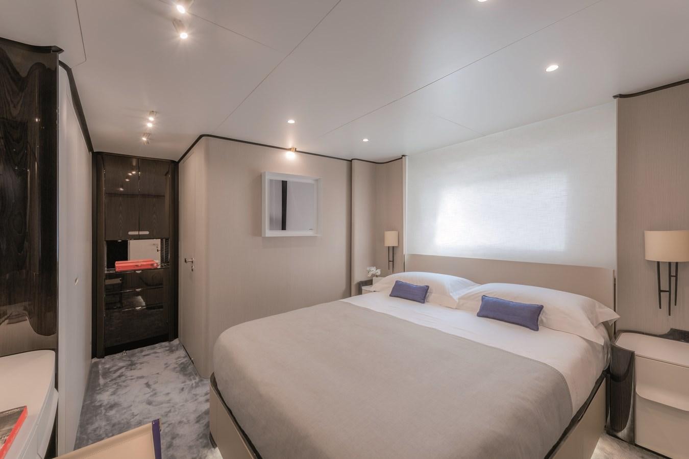 a bedroom with a bed and a mirror aboard LA MAMA Yacht for Sale