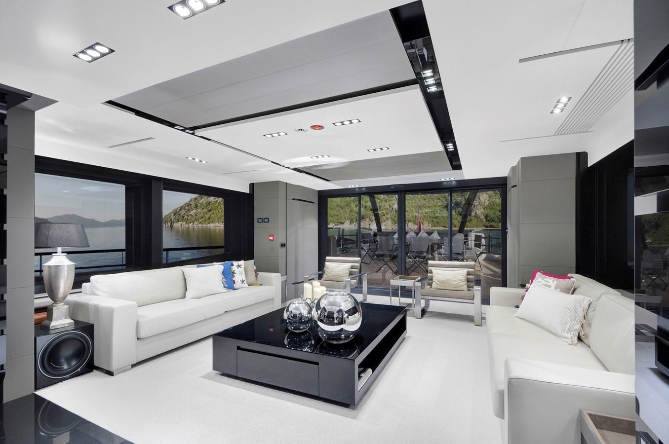 a living room with white furniture aboard FX Yacht for Sale