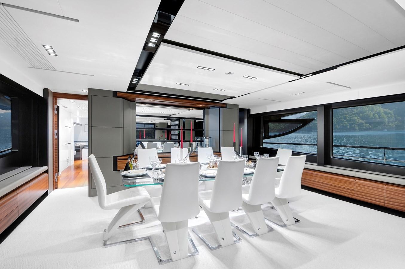 a room with white chairs and a table with white chairs aboard FX Yacht for Charter