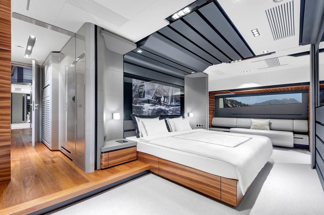a room with a bed and a large mirror aboard FX Yacht for Sale