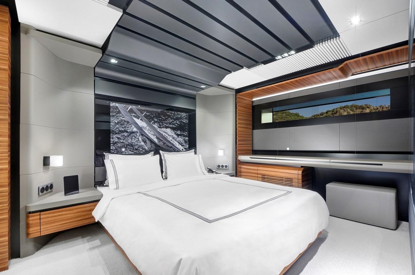 a room with a bed and a television aboard FX Yacht for Charter