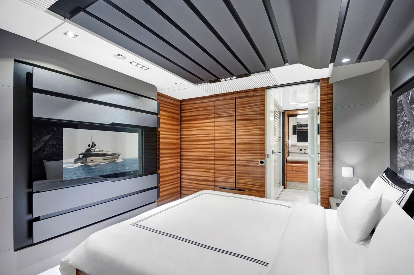 a room with a bed and a television aboard FX Yacht for Sale