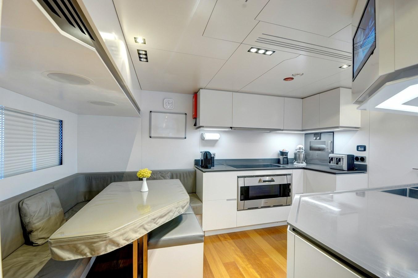 a kitchen with white cabinets aboard FX Yacht for Sale