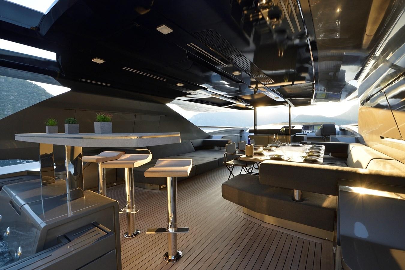a room with tables and chairs aboard FX Yacht for Sale