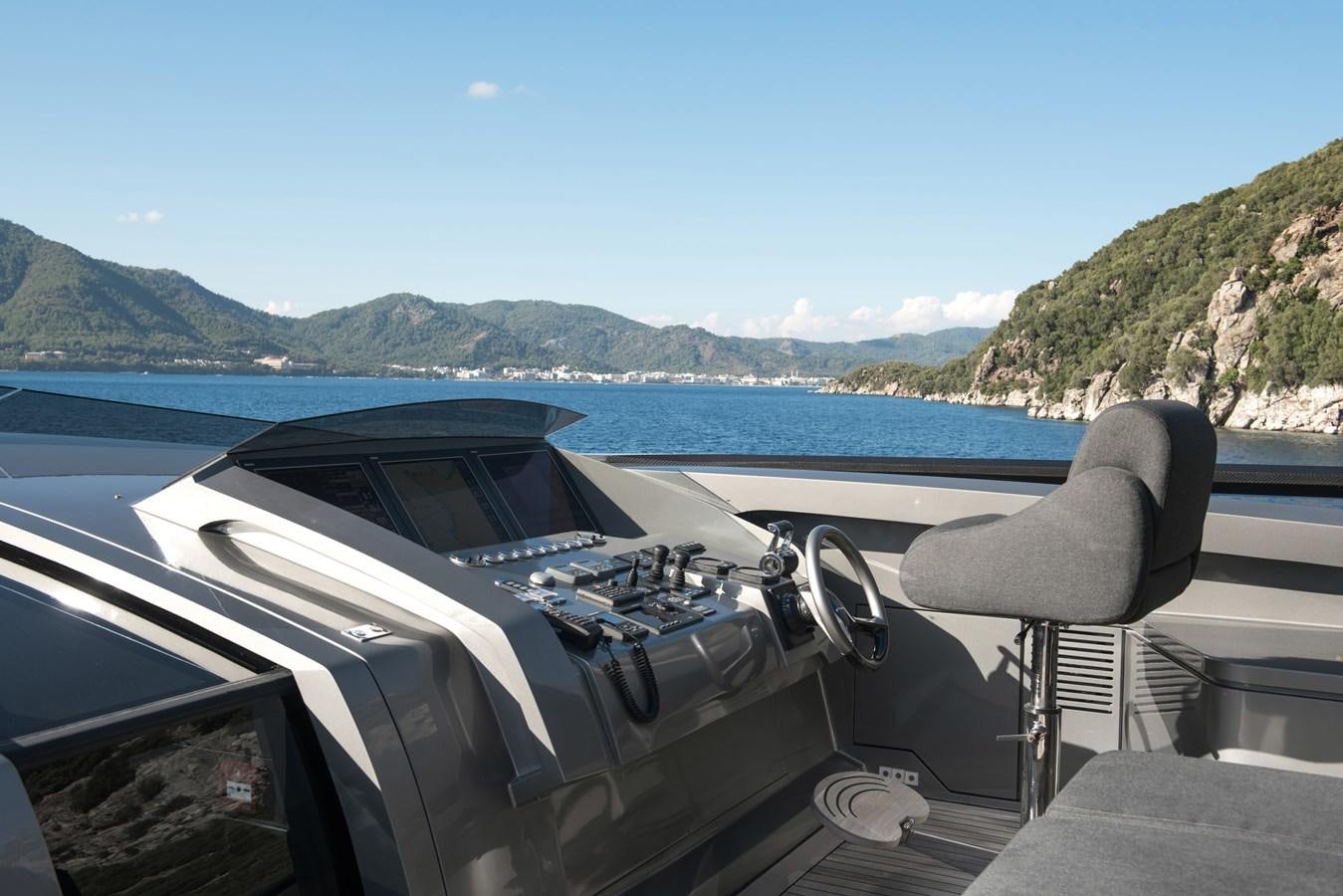 the interior of a car with a lake and mountains in the background aboard FX Yacht for Sale