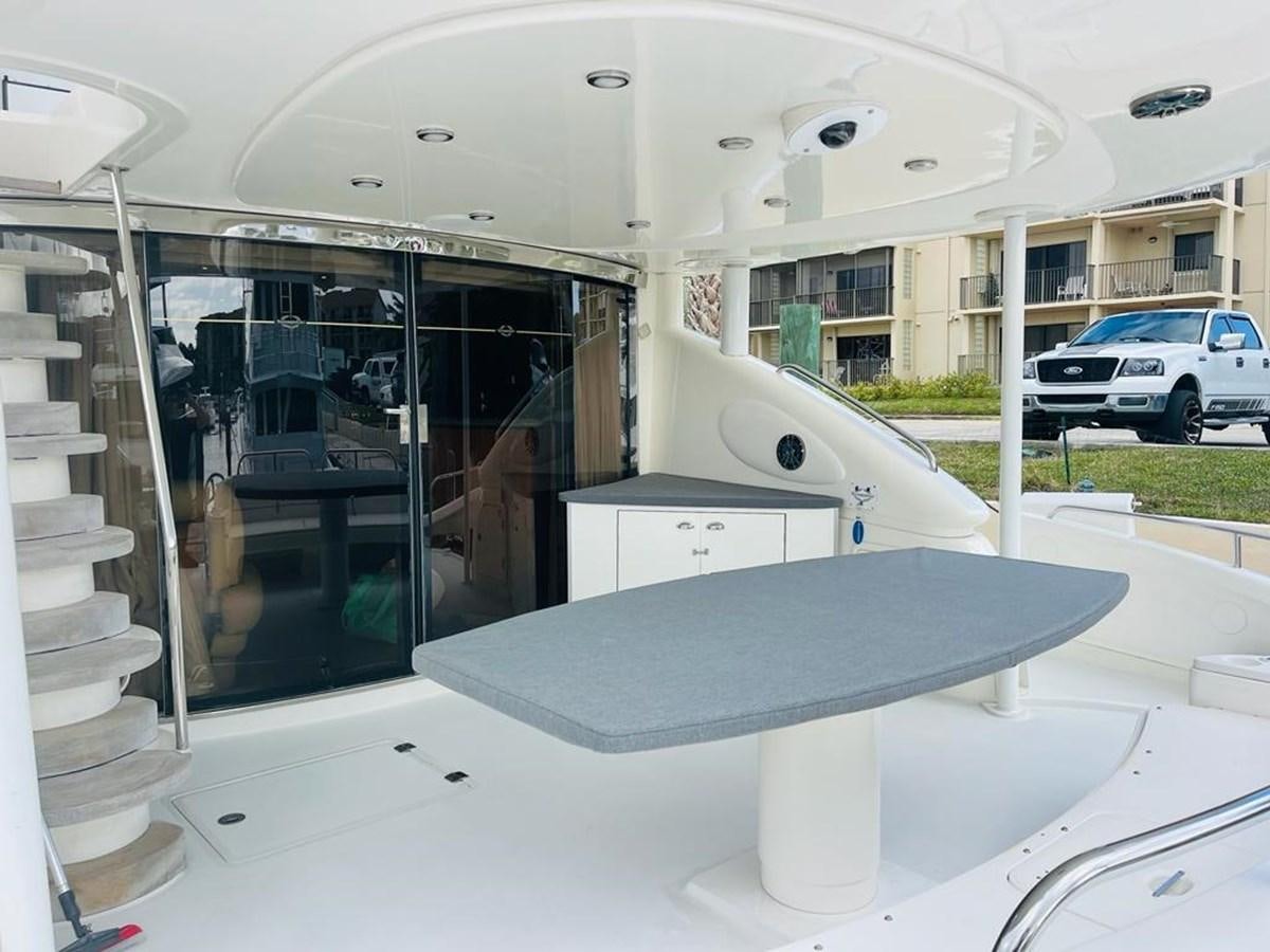 a large white table with a glass door and a white table with chairs aboard LADY ESTHER  Yacht for Sale