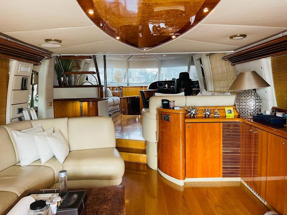 a living room with a large open kitchen and dining area aboard LADY ESTHER  Yacht for Sale