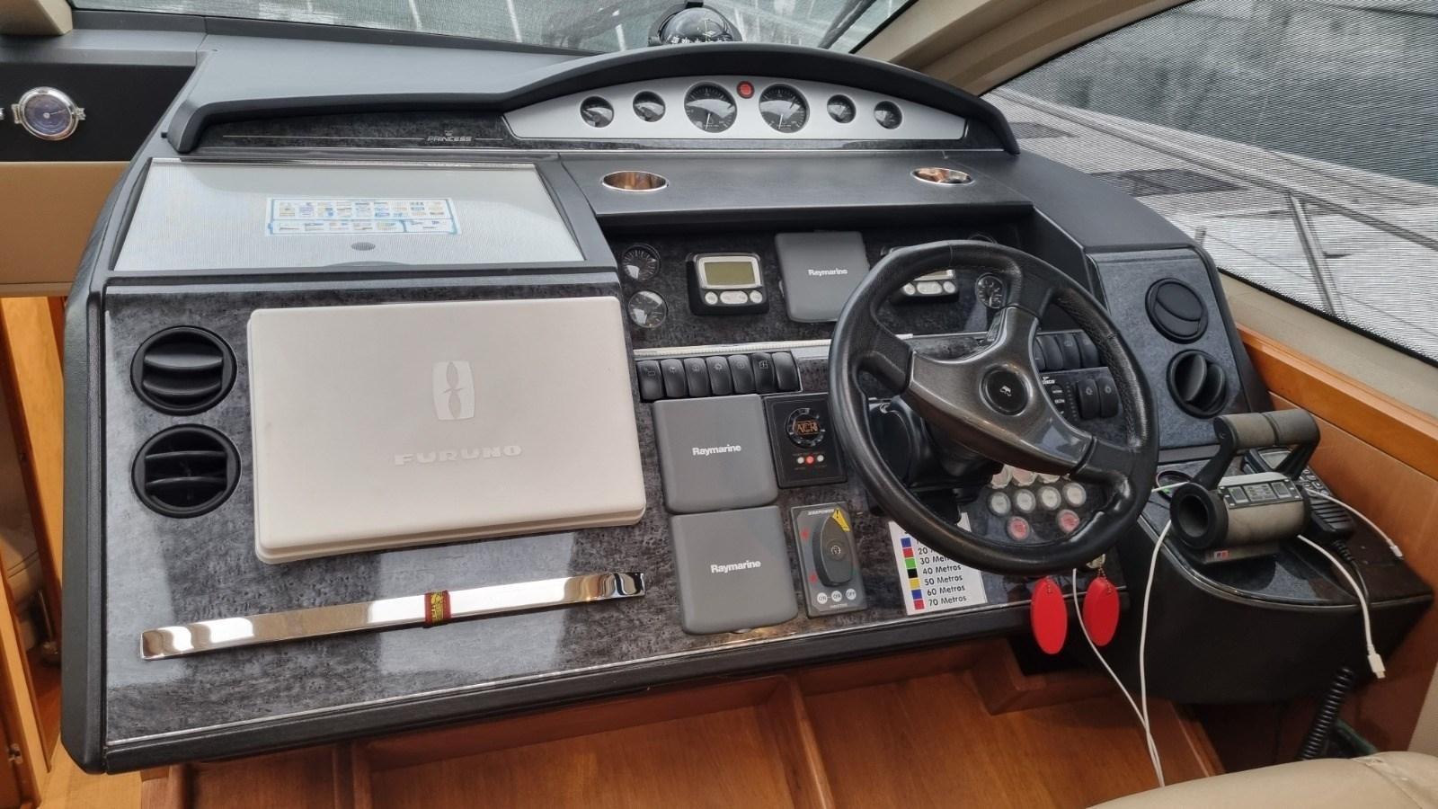 a car stereo with a pen and other objects on it aboard SERENA Yacht for Sale