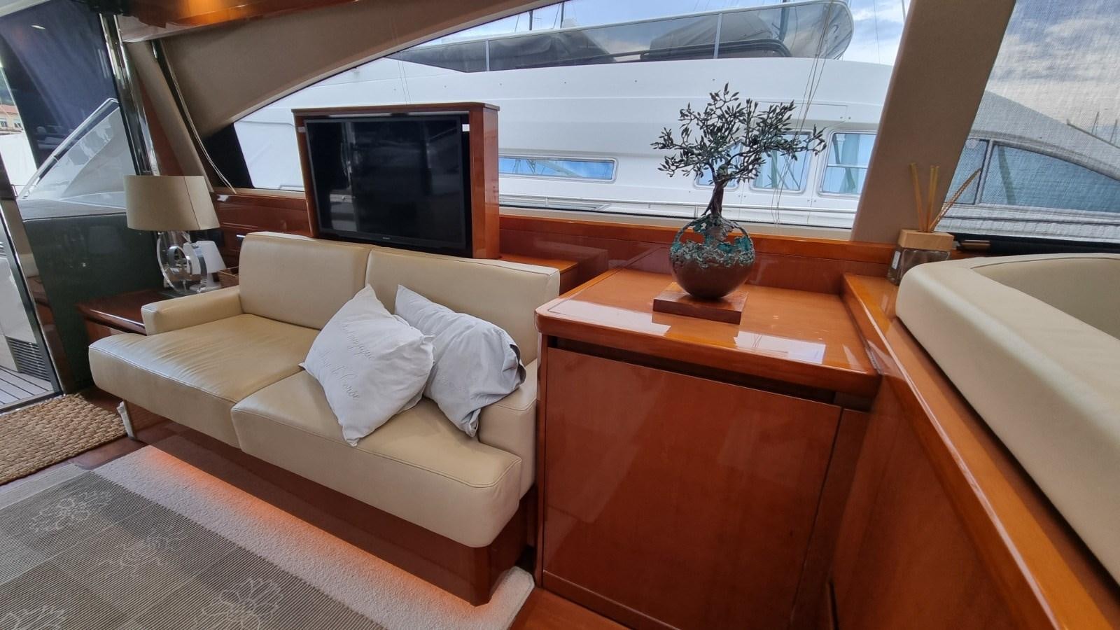 a living room with a couch and a television aboard SERENA Yacht for Sale