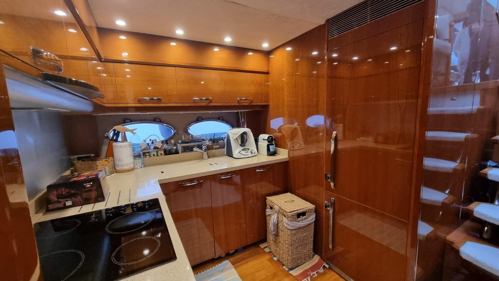 a kitchen with wooden cabinets aboard SERENA Yacht for Sale