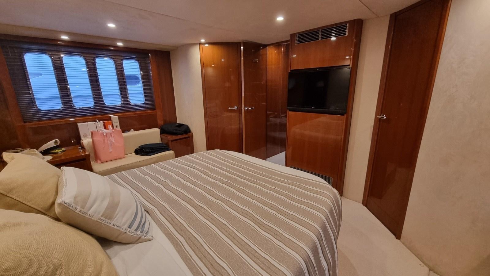 a room with a bed and a tv aboard SERENA Yacht for Sale