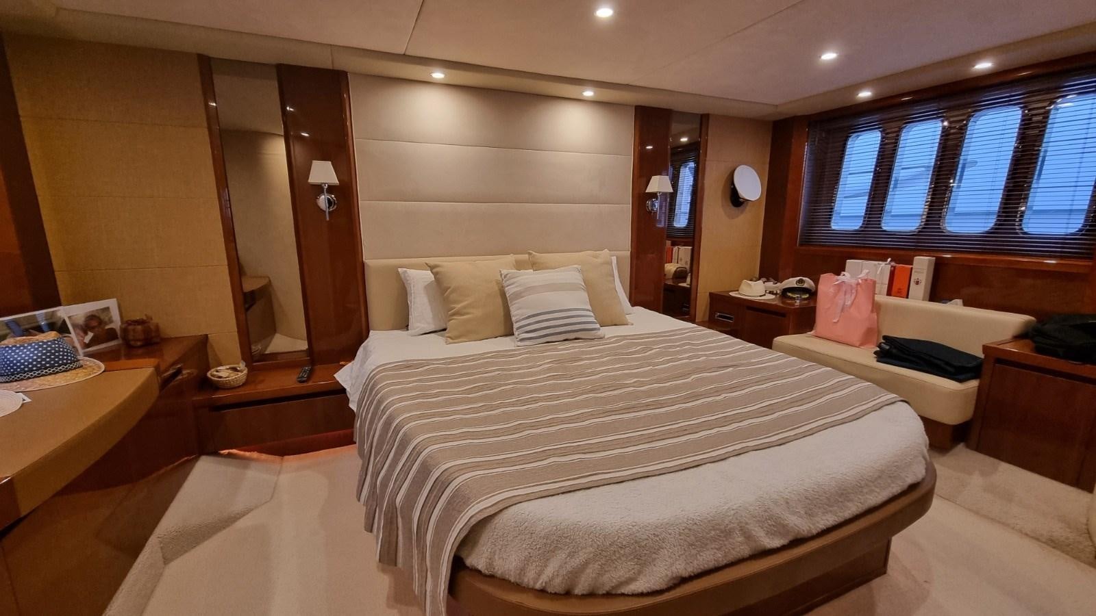 a room with a bed and a window aboard SERENA Yacht for Sale