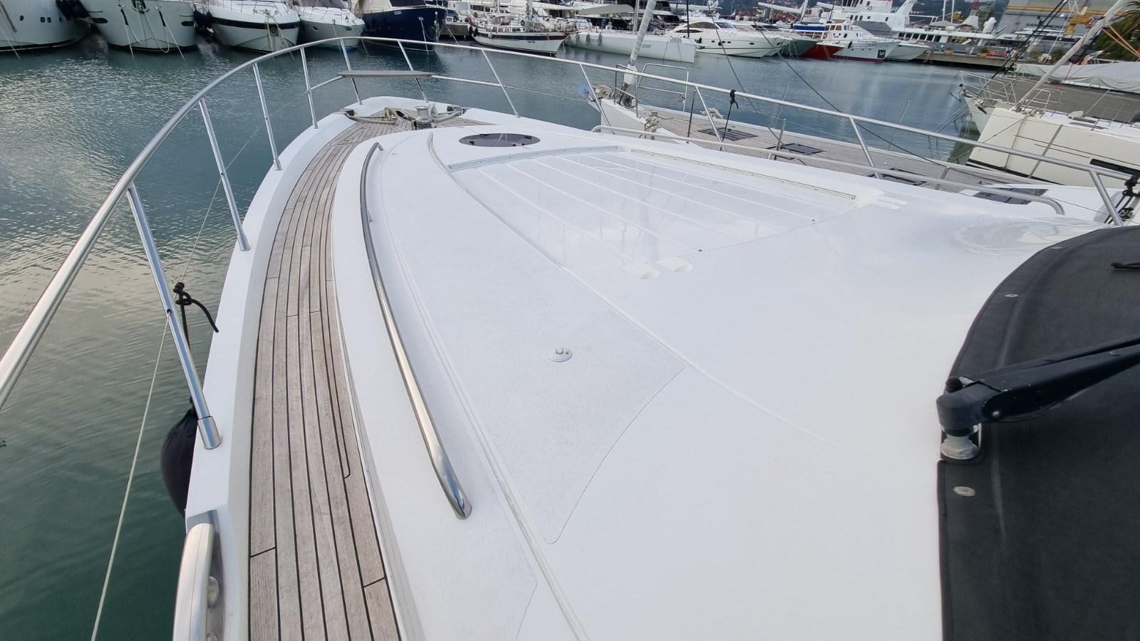 a white boat on a body of water aboard SERENA Yacht for Sale