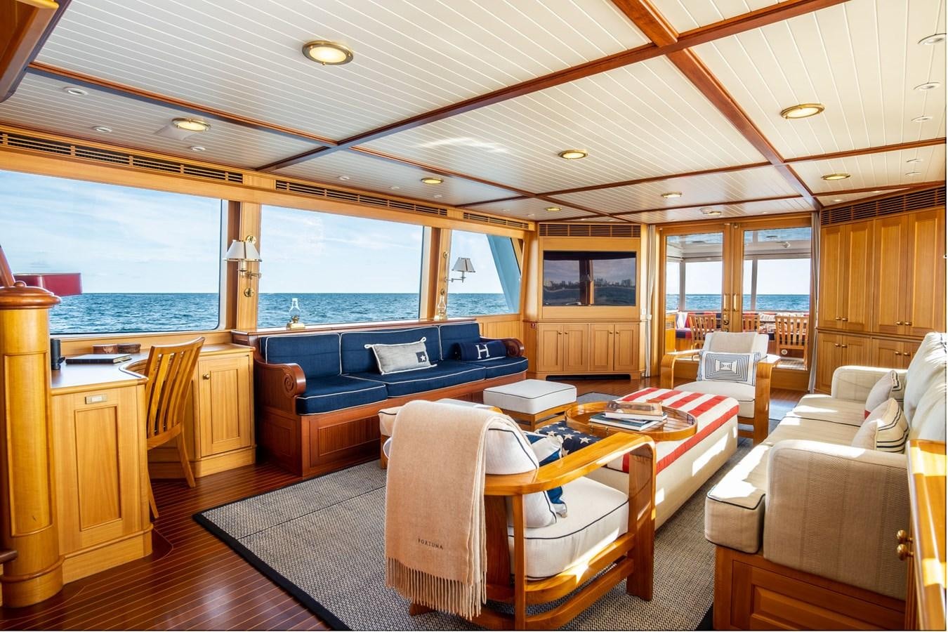 a living room with a large window aboard FORTUNA Yacht for Sale