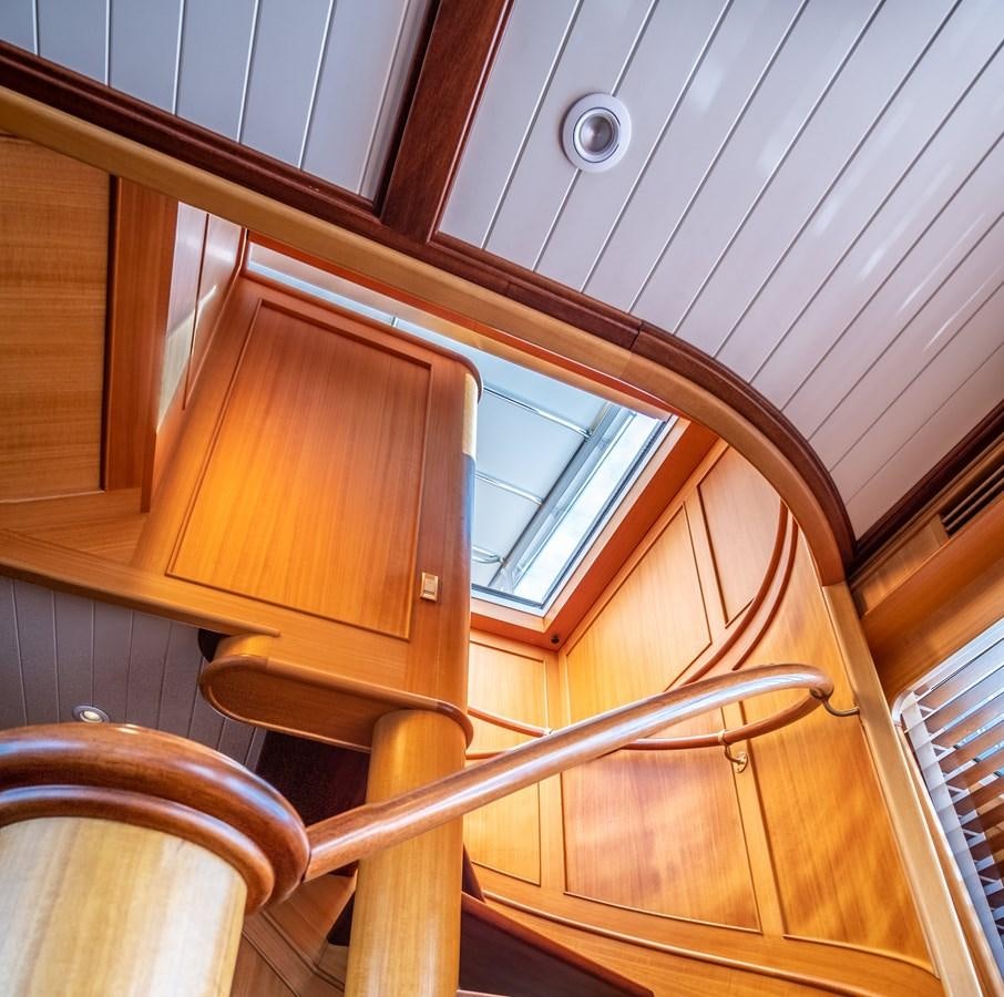 a wooden staircase with wooden railings aboard FORTUNA Yacht for Sale