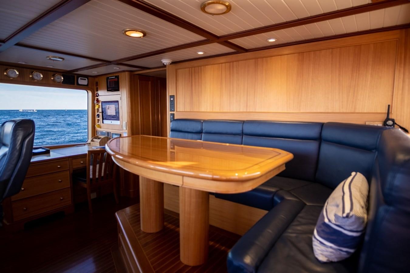 a room with a table and chairs aboard FORTUNA Yacht for Sale