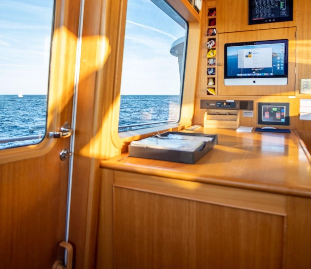a room with a tv and a window aboard FORTUNA Yacht for Sale