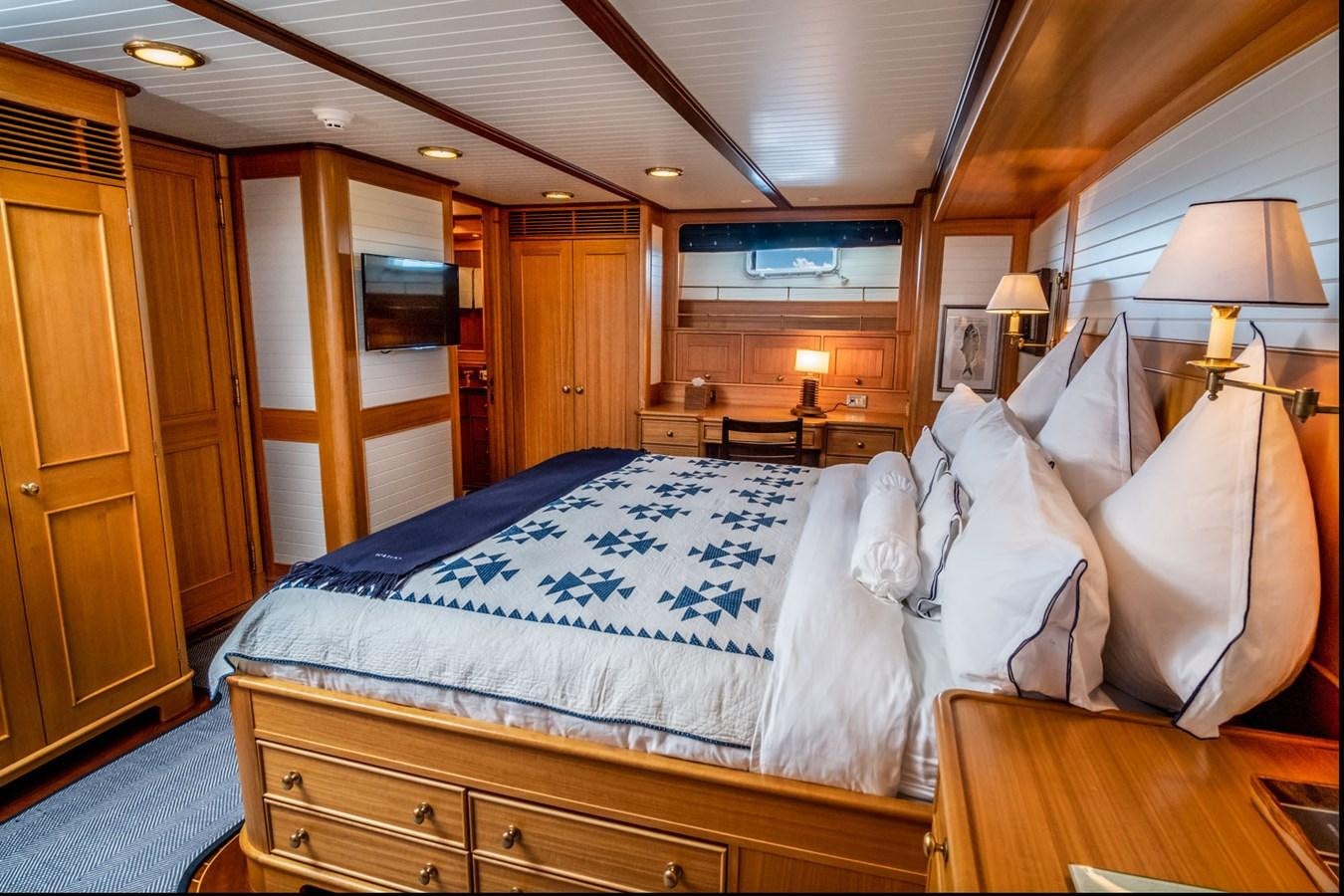 a bed with white sheets aboard FORTUNA Yacht for Sale