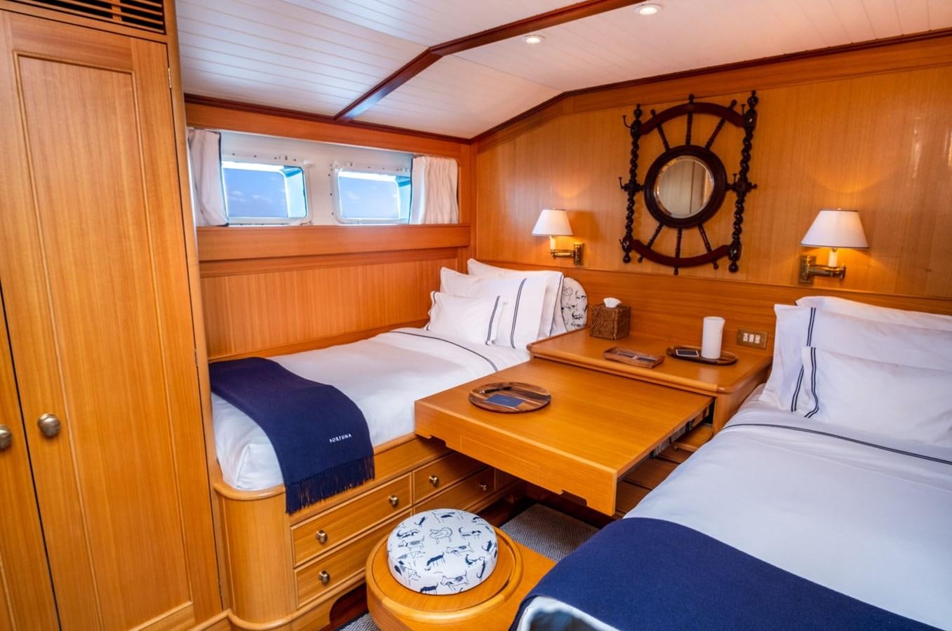 a room with a bed and a desk aboard FORTUNA Yacht for Sale