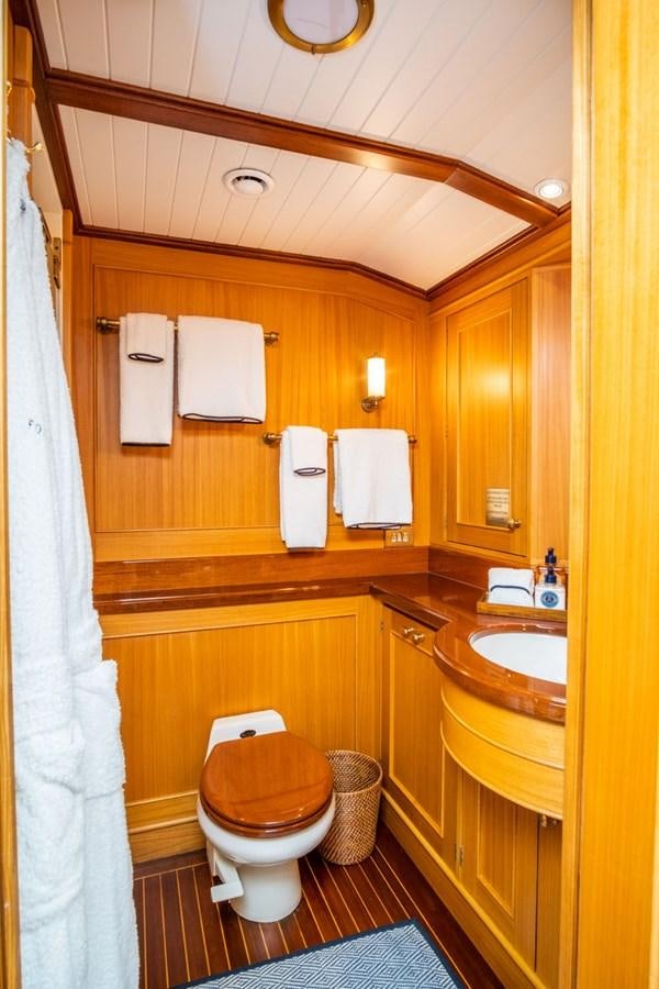 a bathroom with a toilet and sink aboard FORTUNA Yacht for Sale