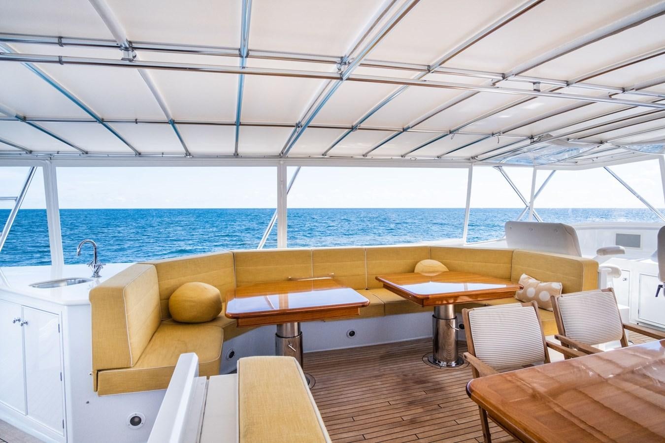 a room with a table and chairs aboard FORTUNA Yacht for Sale