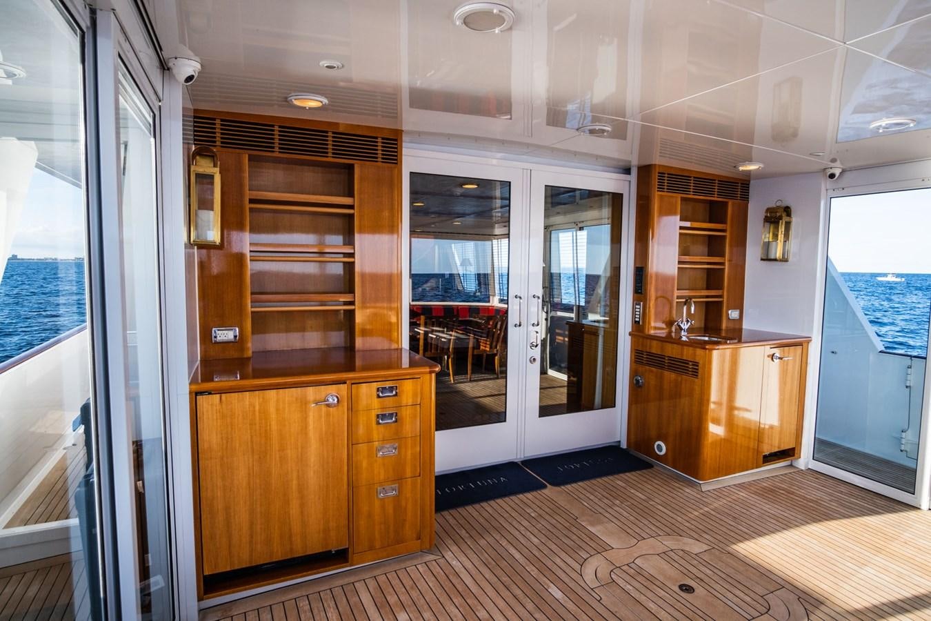 a room with wooden cabinets aboard FORTUNA Yacht for Sale