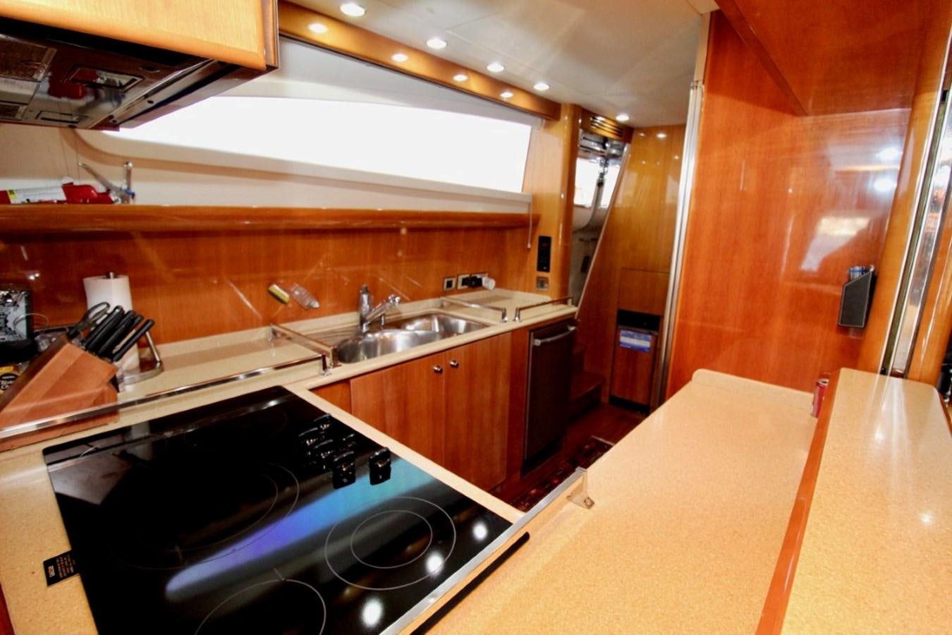 a kitchen with wooden cabinets aboard AVICCI Yacht for Sale