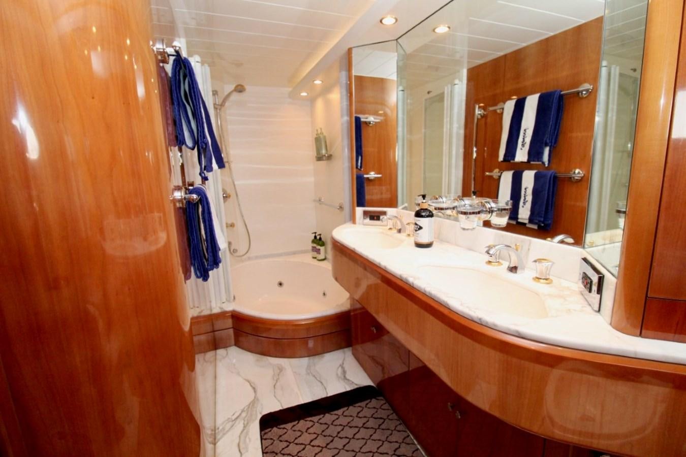 a bathroom with a tub sink and a mirror aboard AVICCI Yacht for Sale