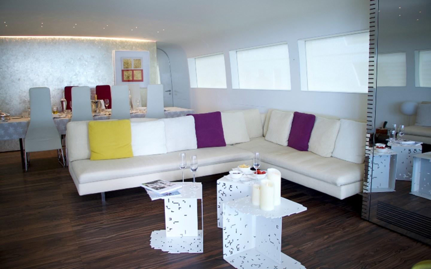a living room with a couch and a table aboard PAB Yacht for Sale