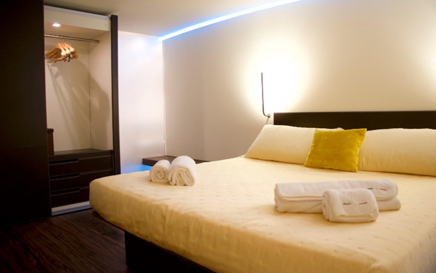 a bed with pillows and a mirror aboard PAB Yacht for Sale