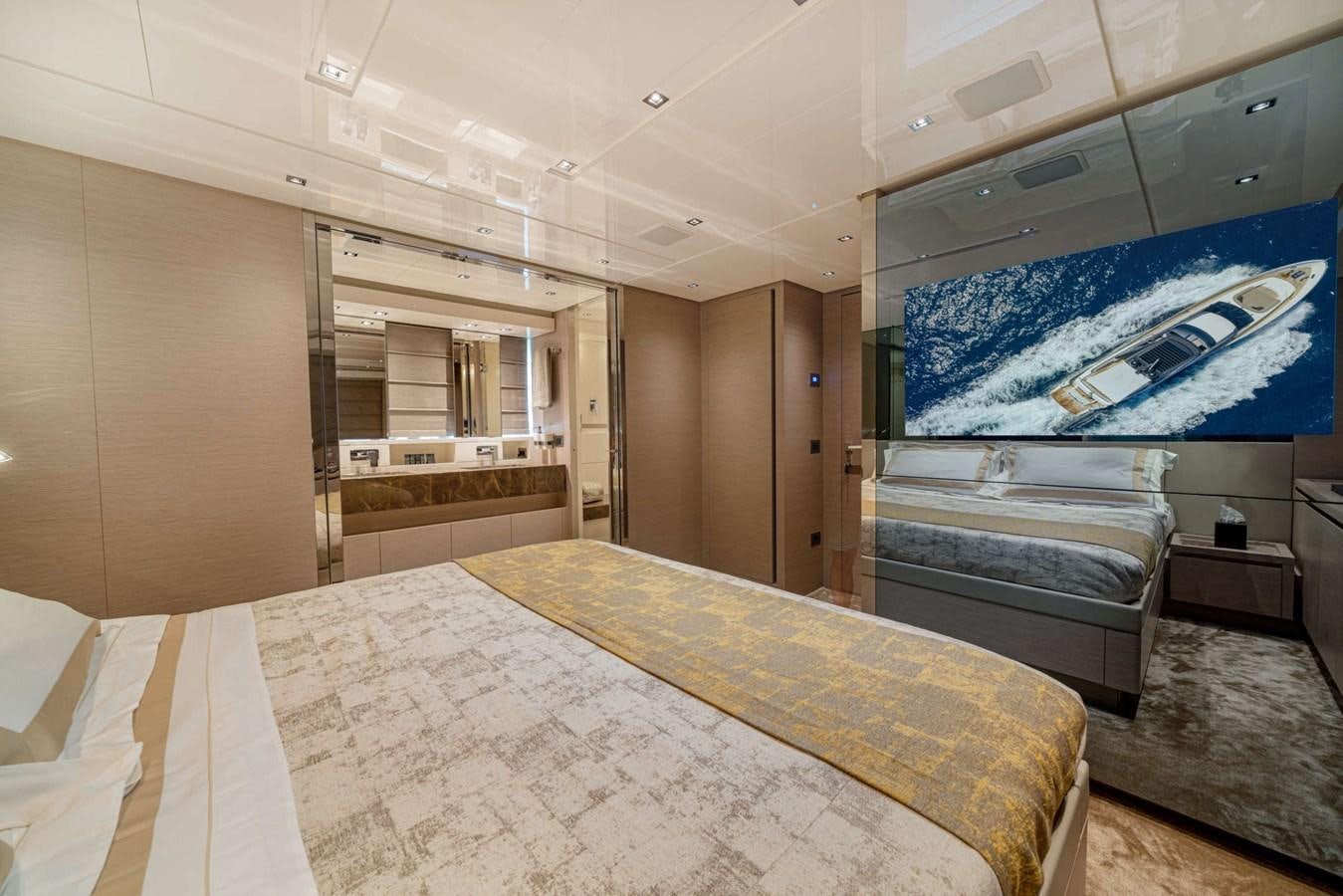 a room with a bed and a painting on the wall aboard LUCKY Yacht for Sale