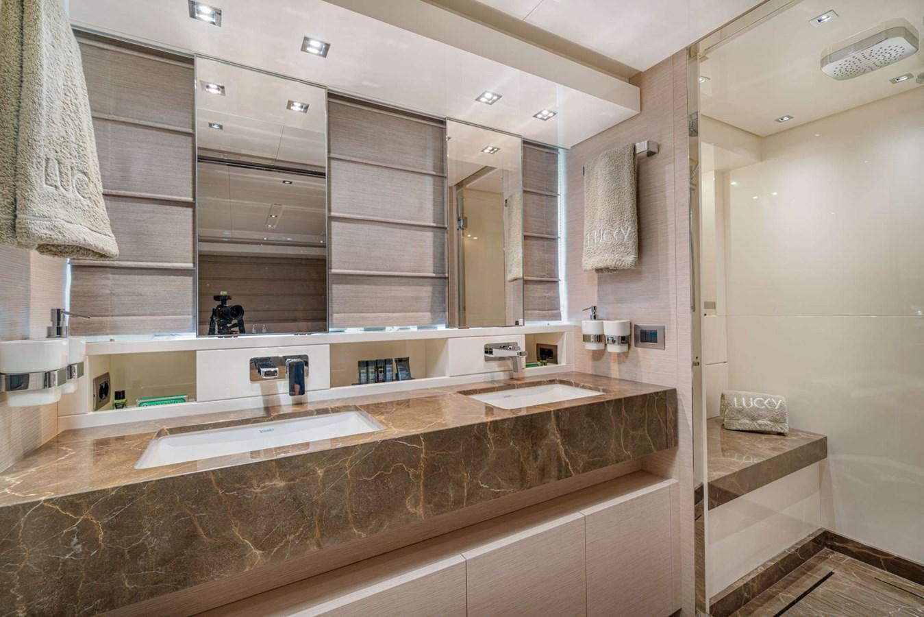 a bathroom with a large mirror aboard LUCKY Yacht for Sale